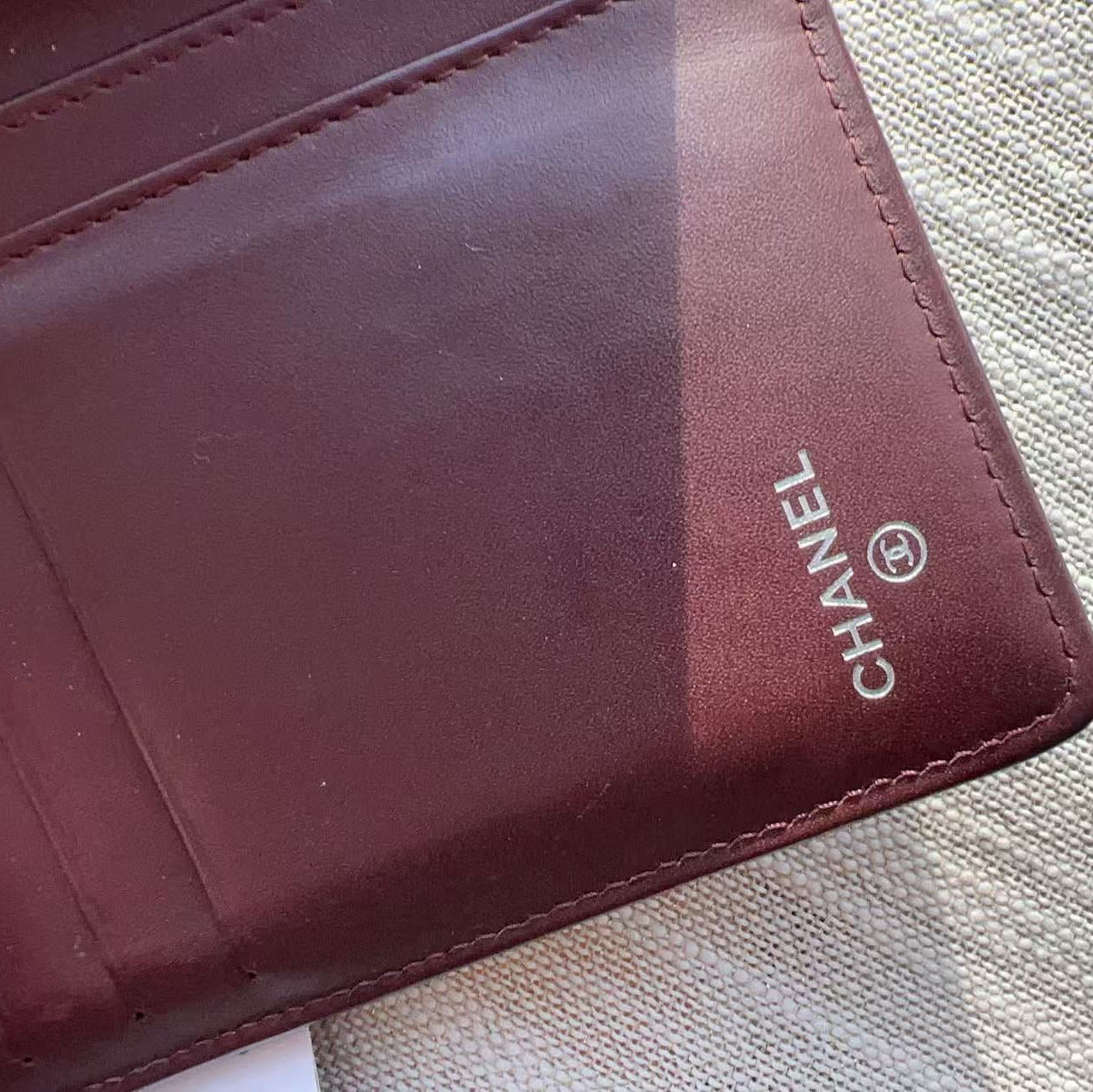 Close-up of a Chanel wallet on a textured surface