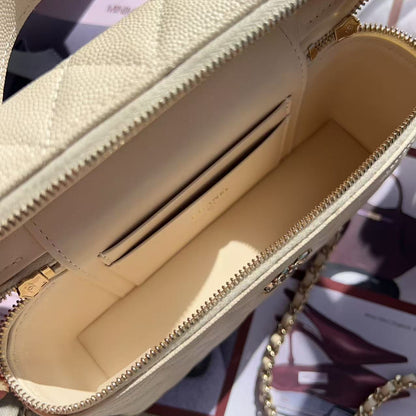 Close-up of a beige handbag with gold chain detail on a blurred background