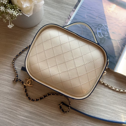 Heart-shaped beige bra with a chain on a wooden surface with flowers and a book in the background