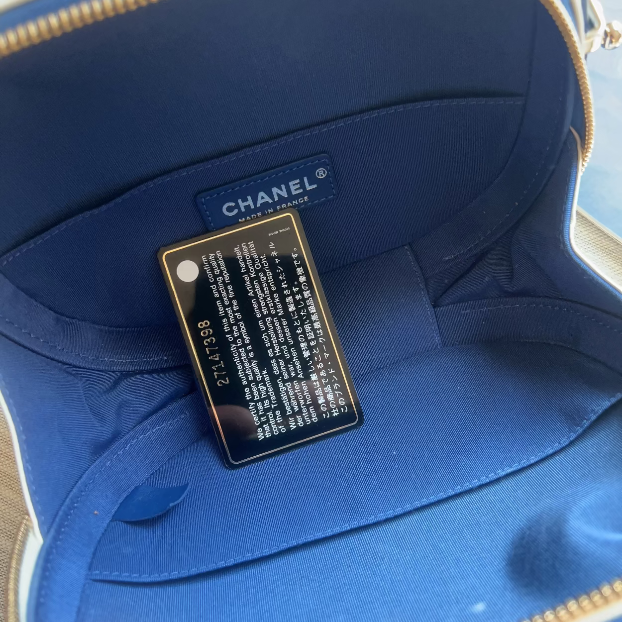 Blue Chanel handbag with a visible brand label.