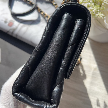 Black leather case with gold accents on a light background