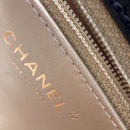 Close-up of Chanel logo on a product with a zipper.