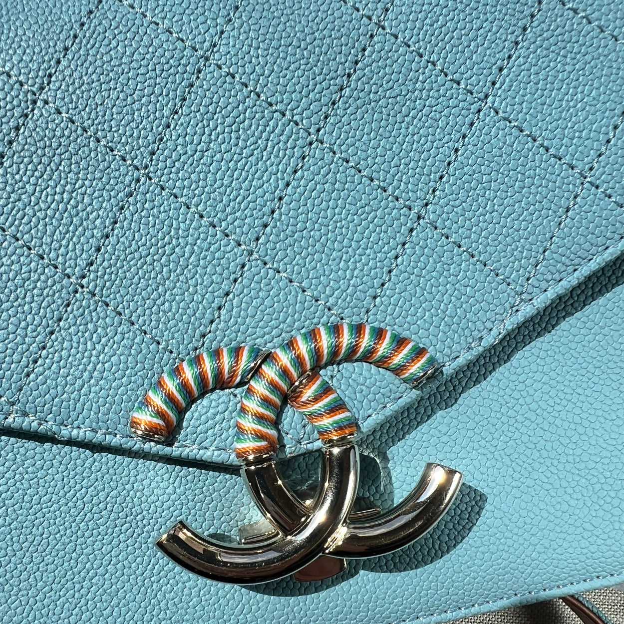 Close-up of a blue textured surface with a decorative metal element.