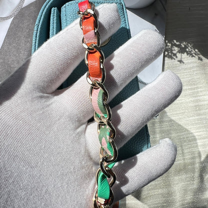 Multicolored chain bracelet on a gray surface