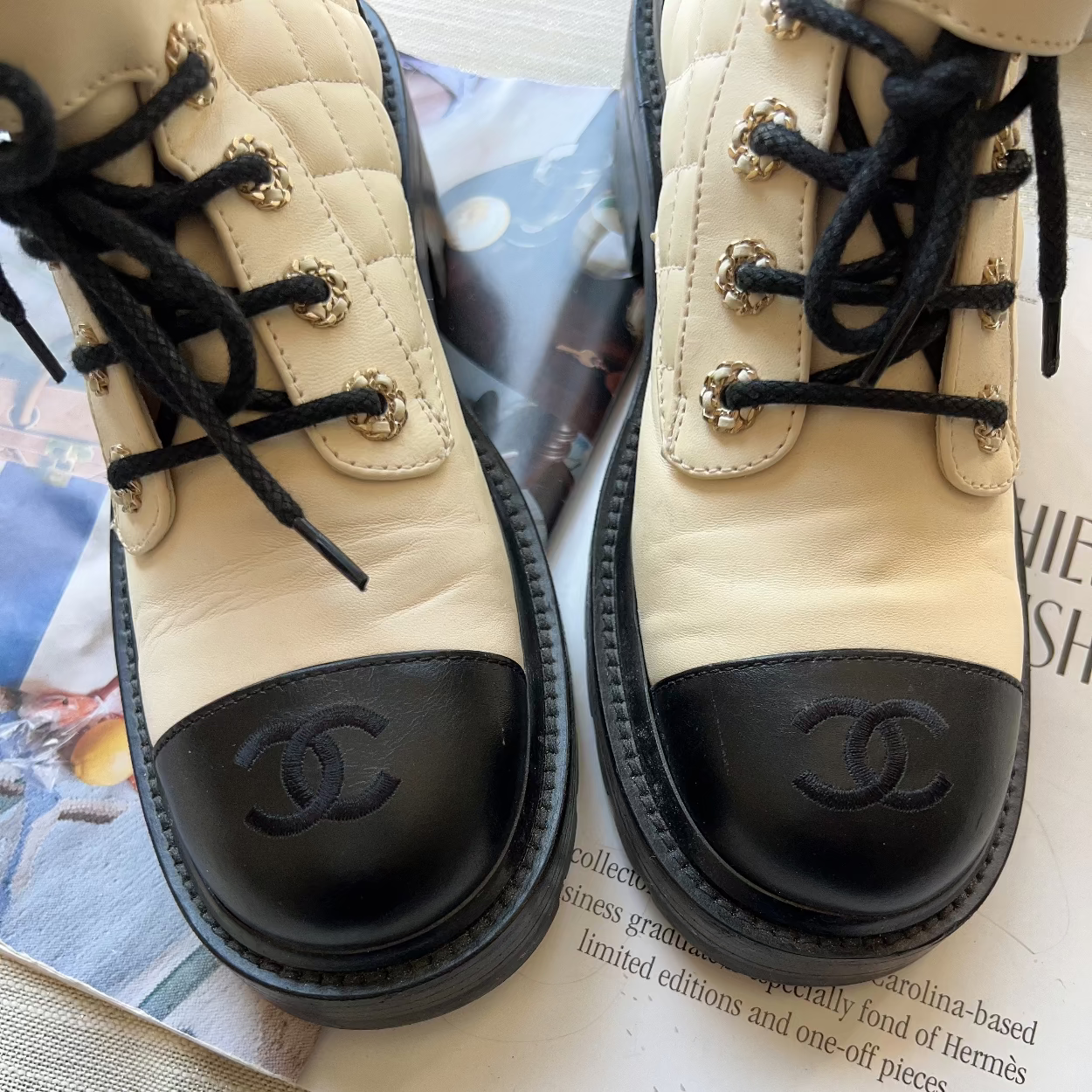 Pair of beige and black Chanel shoes on a magazine