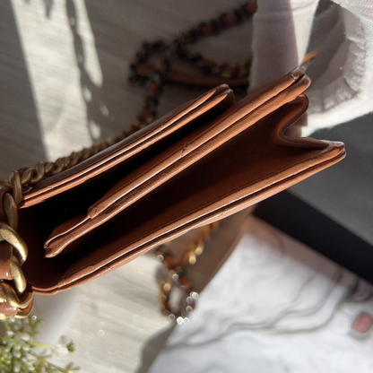 Close-up of a brown leather wallet with a blurred background