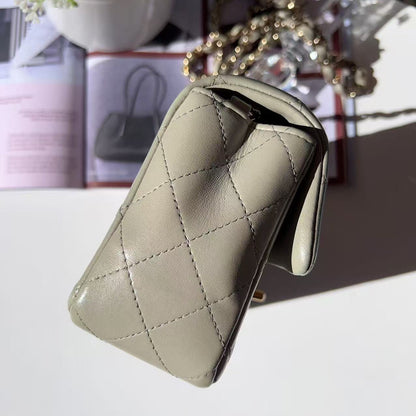 Beige quilted wallet on a white surface with blurred background