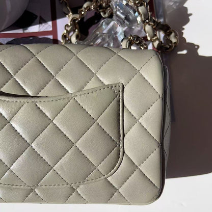 Quilted beige handbag on a white background