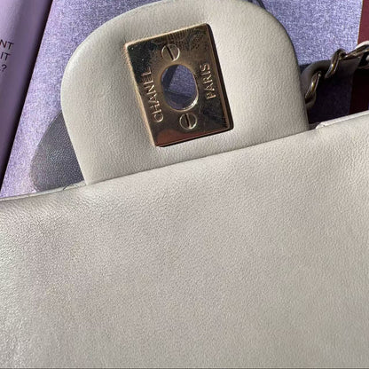 Close-up of a Chanel handbag with the brand logo on a magazine background