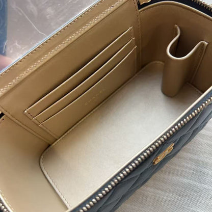 Close-up of the interior of a quilted black handbag with a beige leather organizer insert, showing card slots and a side pocket.