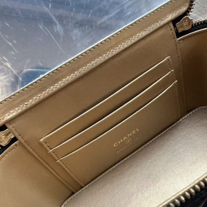 Close-up of the interior of a Chanel handbag showing a beige leather card slot with the gold-embossed CHANEL logo, a clear plastic window, and a dark navy quilted exterior with gold zipper teeth.