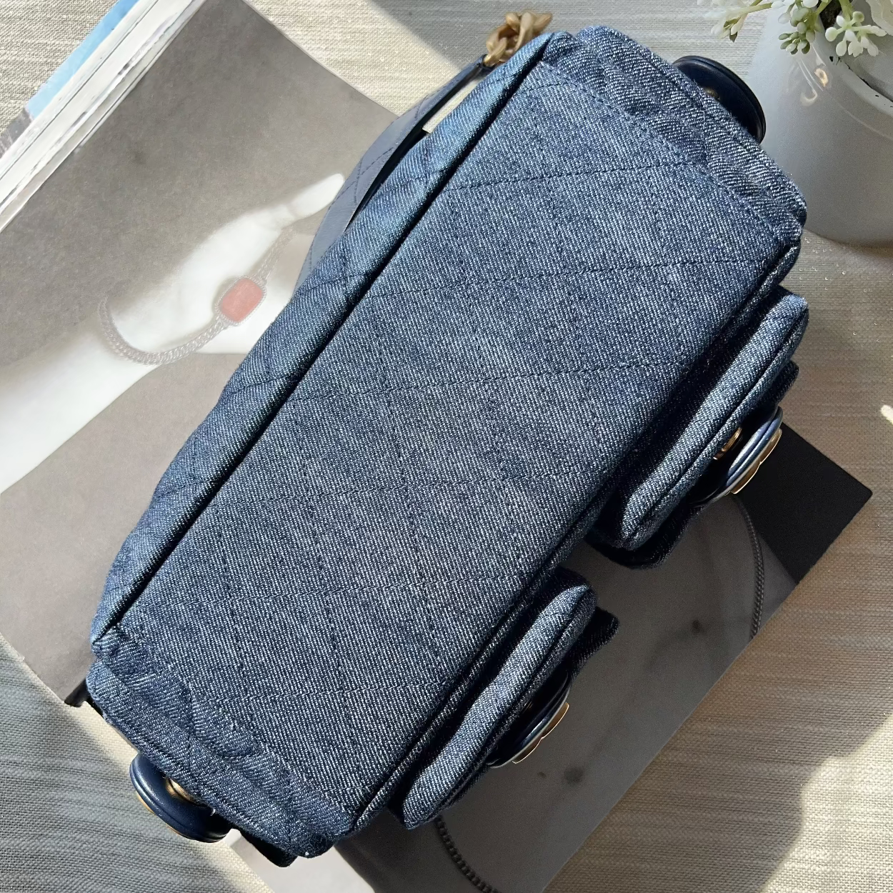 Blue fabric bag with wheels on a wooden surface