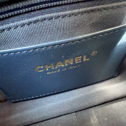 Blue Chanel wallet on a wooden surface