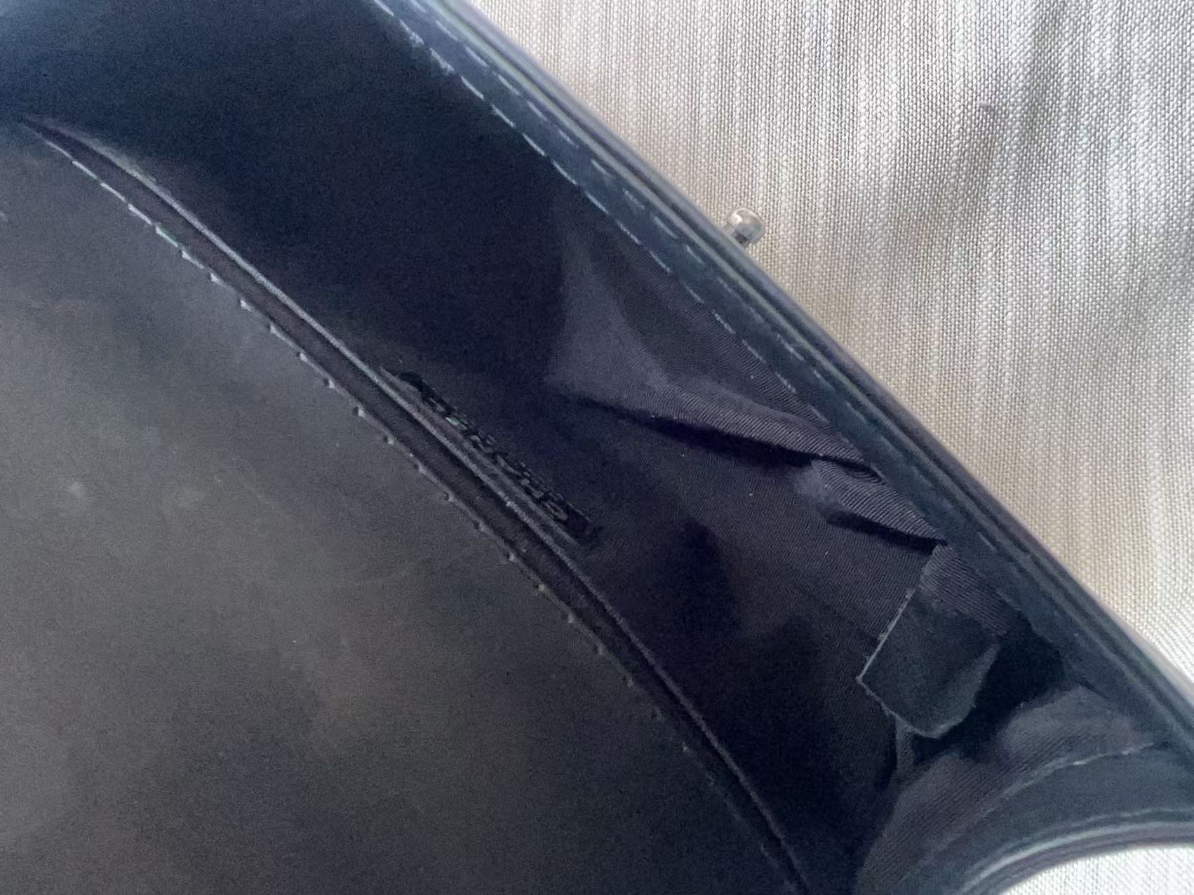 Close-up of a car's sunshade with a brand logo on a textured background