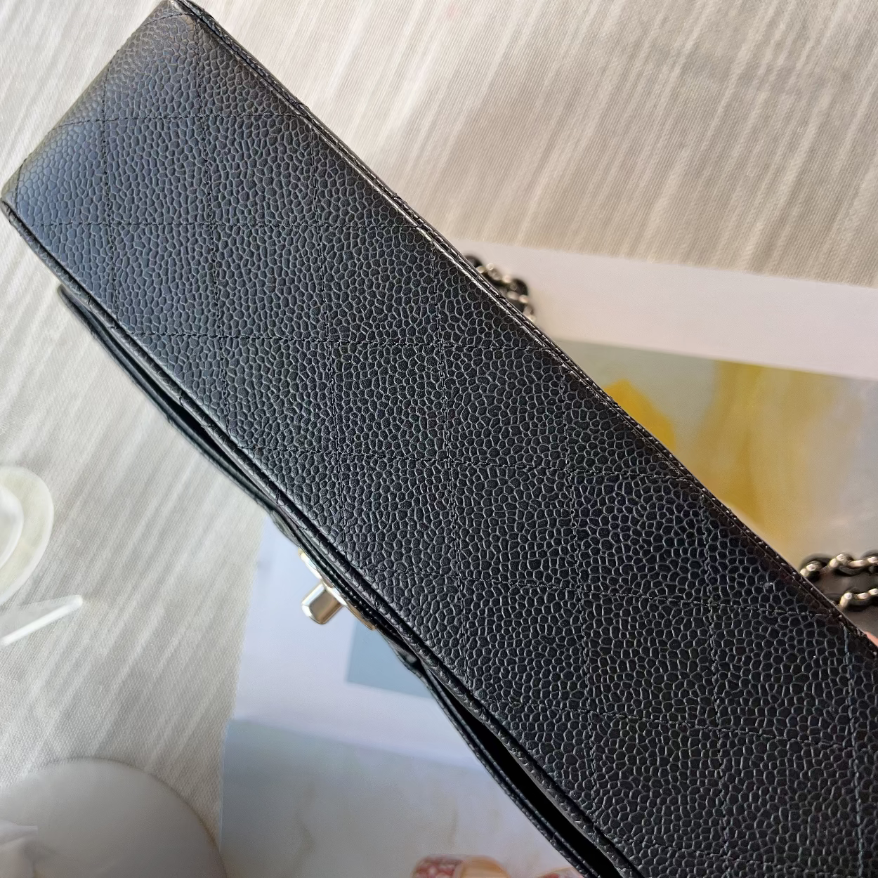 Black leather wallet on a textured surface with a blurred background