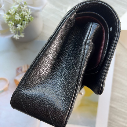 Black leather wallet on a magazine with a blurred background