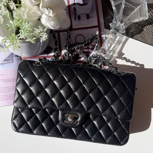 Chanel Black quilted handbag on a decorative stand 
