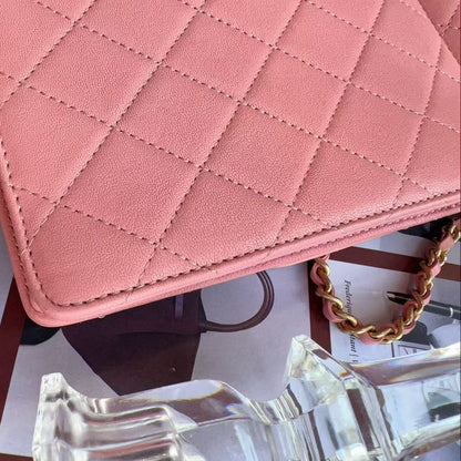 Chanel Pink quilted handbag on a surface with sunglasses 