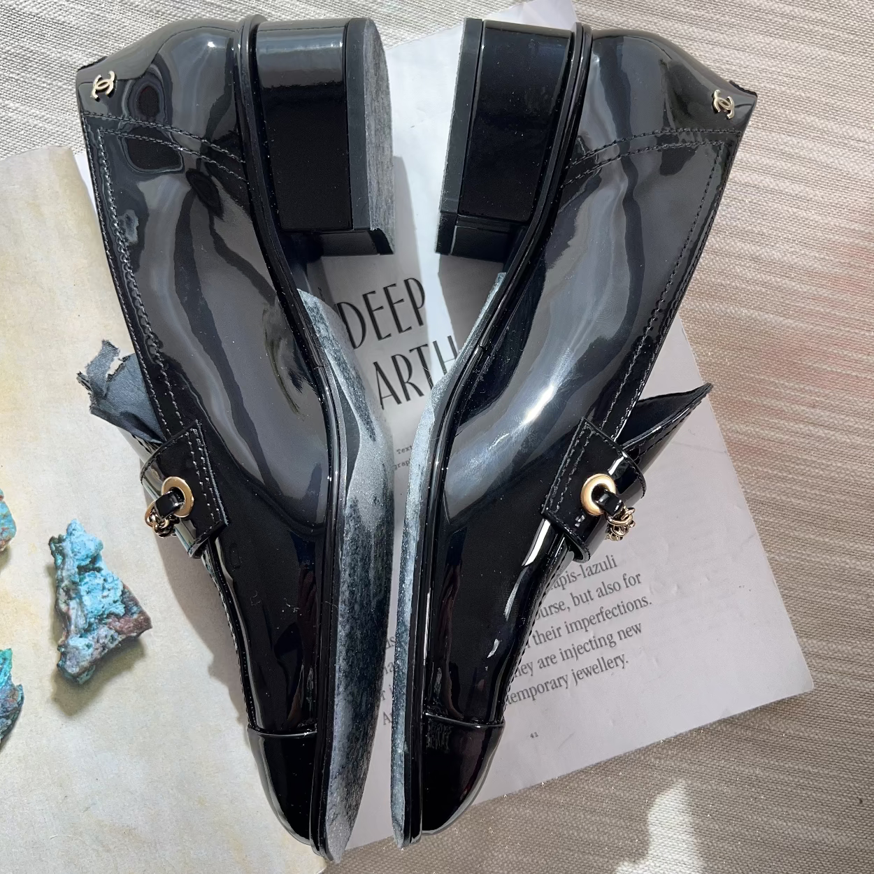 Black high-heeled shoes on a magazine with a textured surface
