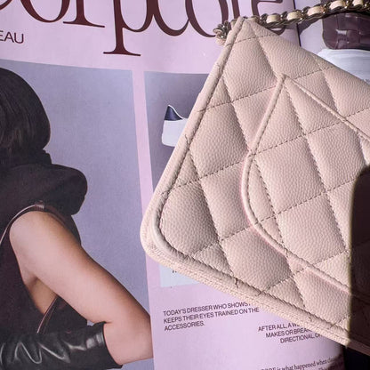 Beige quilted handbag held over a magazine