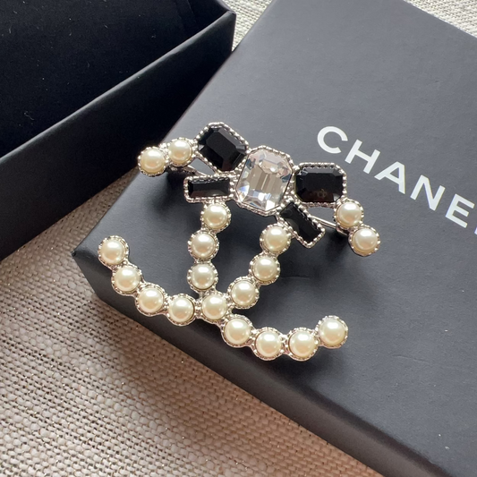 Chanel brooch with pearls on a Chanel box