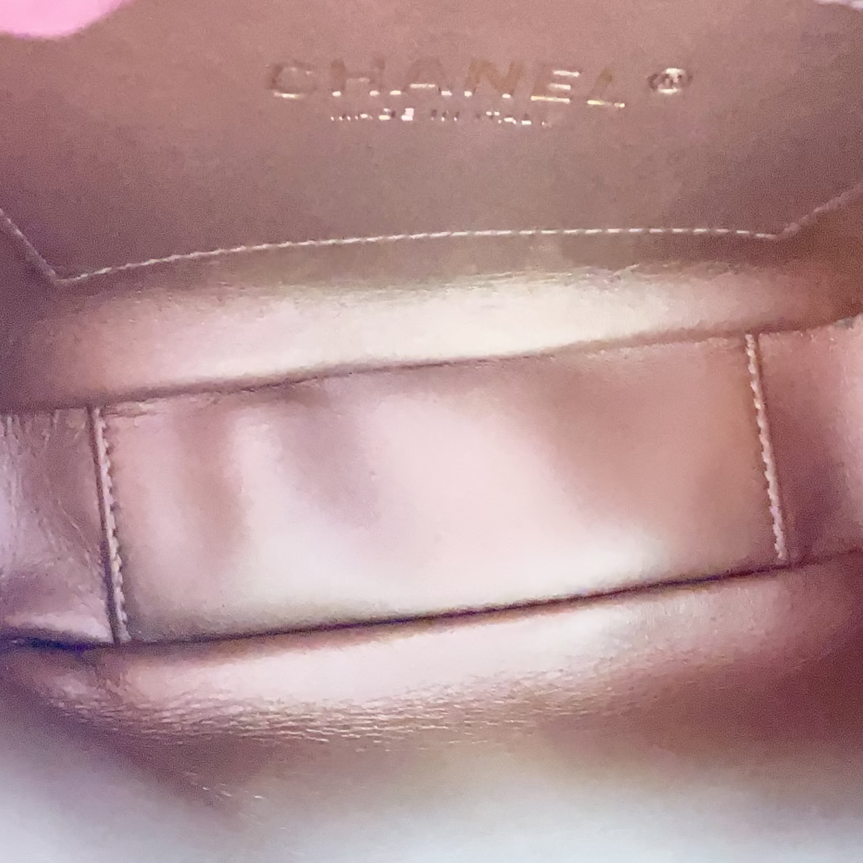 Close-up of a Chanel handbag interior with visible branding.