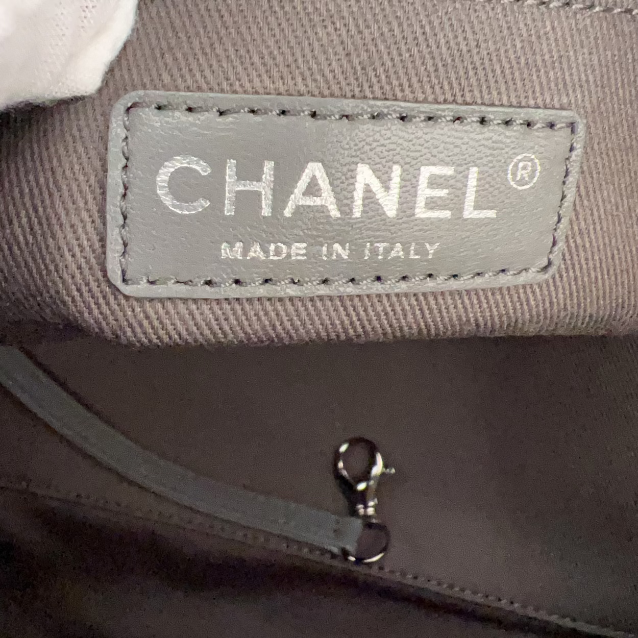 Chanel bag with a visible label on a dark background