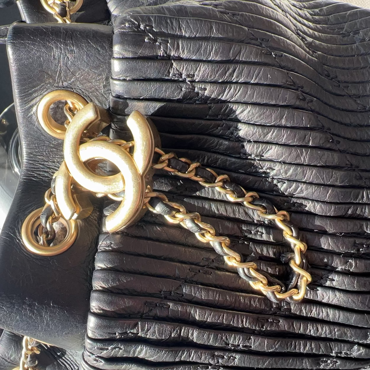 Black leather handbag with gold chain detail