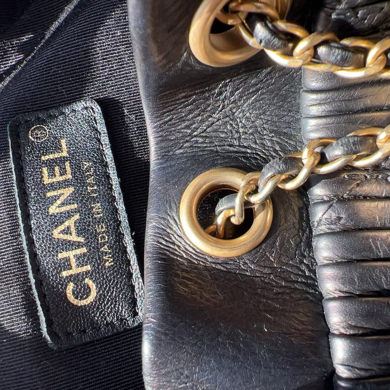 Close-up of a Chanel handbag with gold chain detail