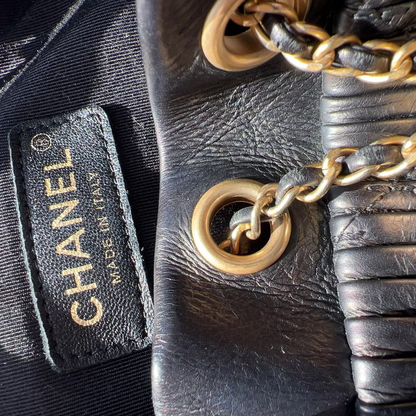 Close-up of a Chanel handbag with gold chain detail