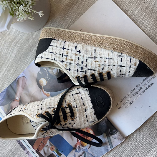 Pair of patterned sneakers on a magazine with a light background