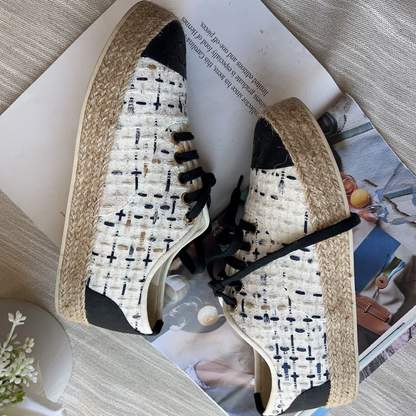 Pair of patterned shoes on a magazine with a light background