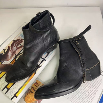 Pair of black leather ankle boots on a magazine