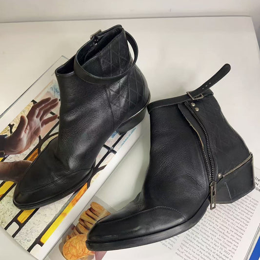 Pair of black leather ankle boots on a magazine