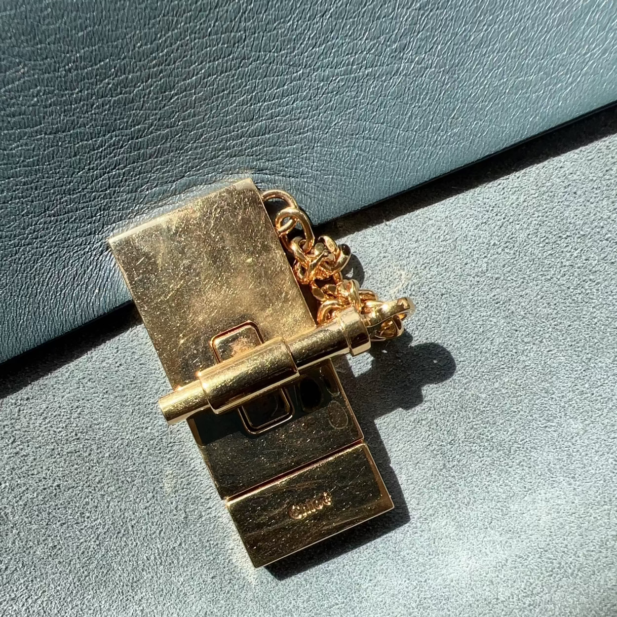 Gold metal clip on a textured gray surface