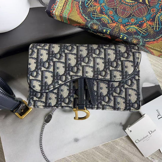 Designer handbag with patterned design on a marble surface, featuring a visible brand tag.