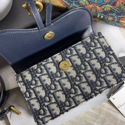 Blue handbag with patterned interior on a textured surface