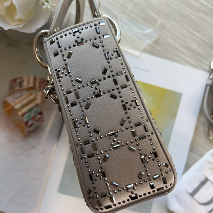 Phone case with decorative cut-out design on a surface with flowers and other items.