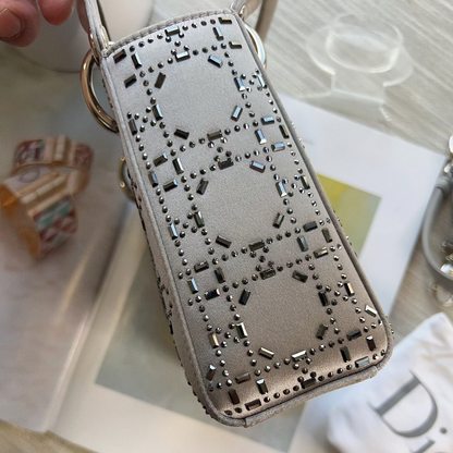 Silver phone case with intricate design on a magazine background