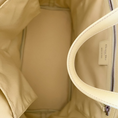 Close-up of a beige jacket with a zipper and handle