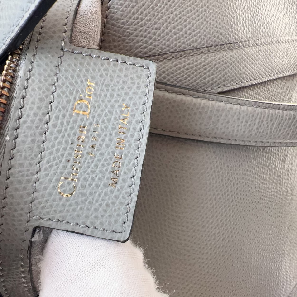 Close-up of a Dior handbag with a visible brand label.