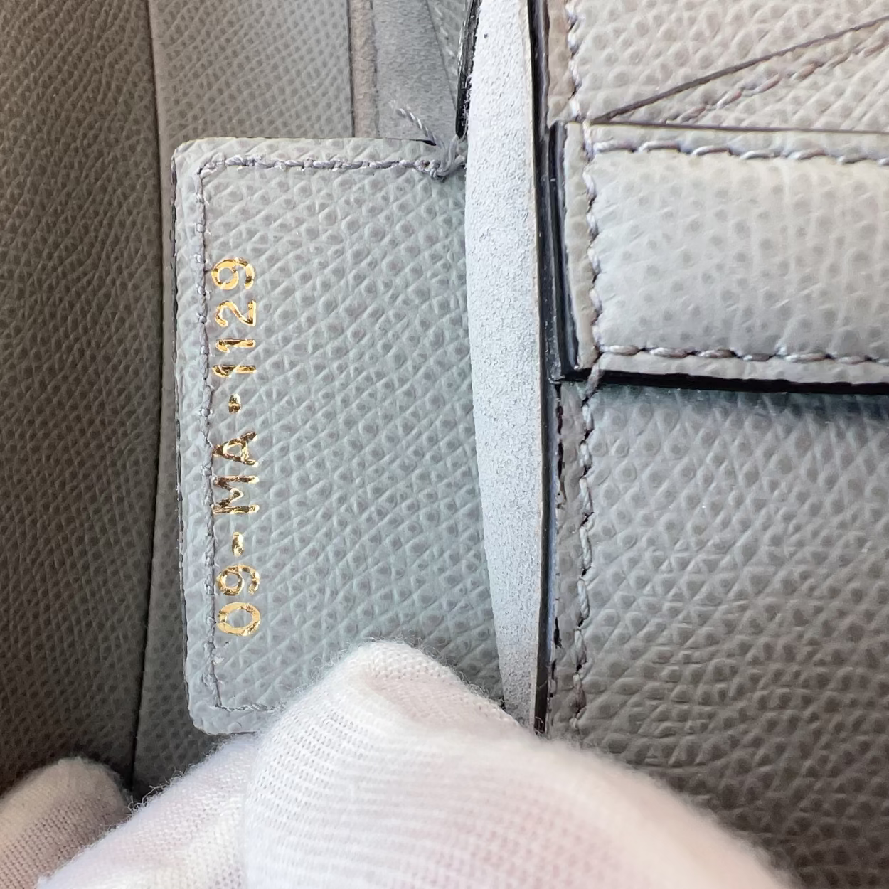Close-up of a textured leather surface with gold embossed text.