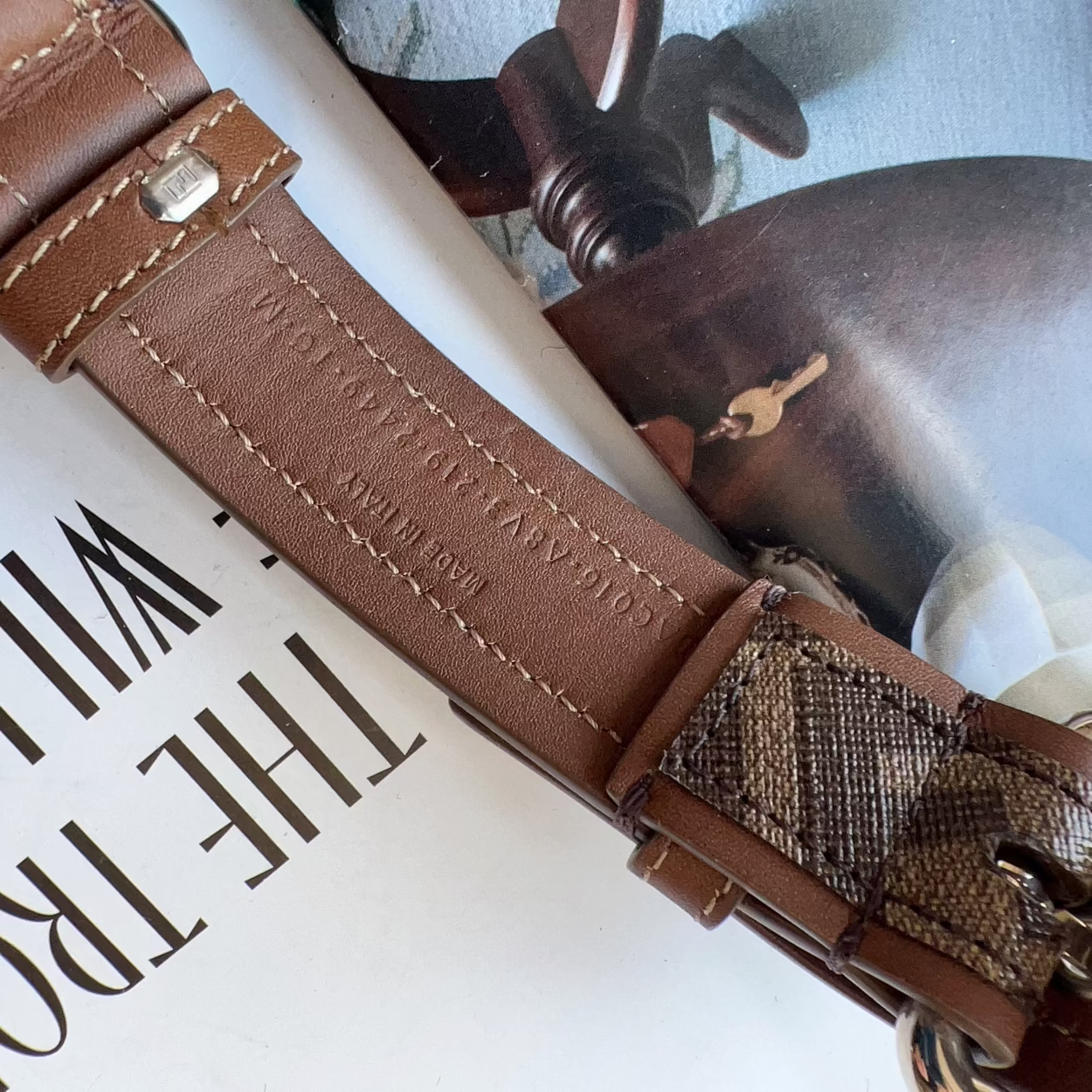 Brown leather strap with decorative pattern on a book