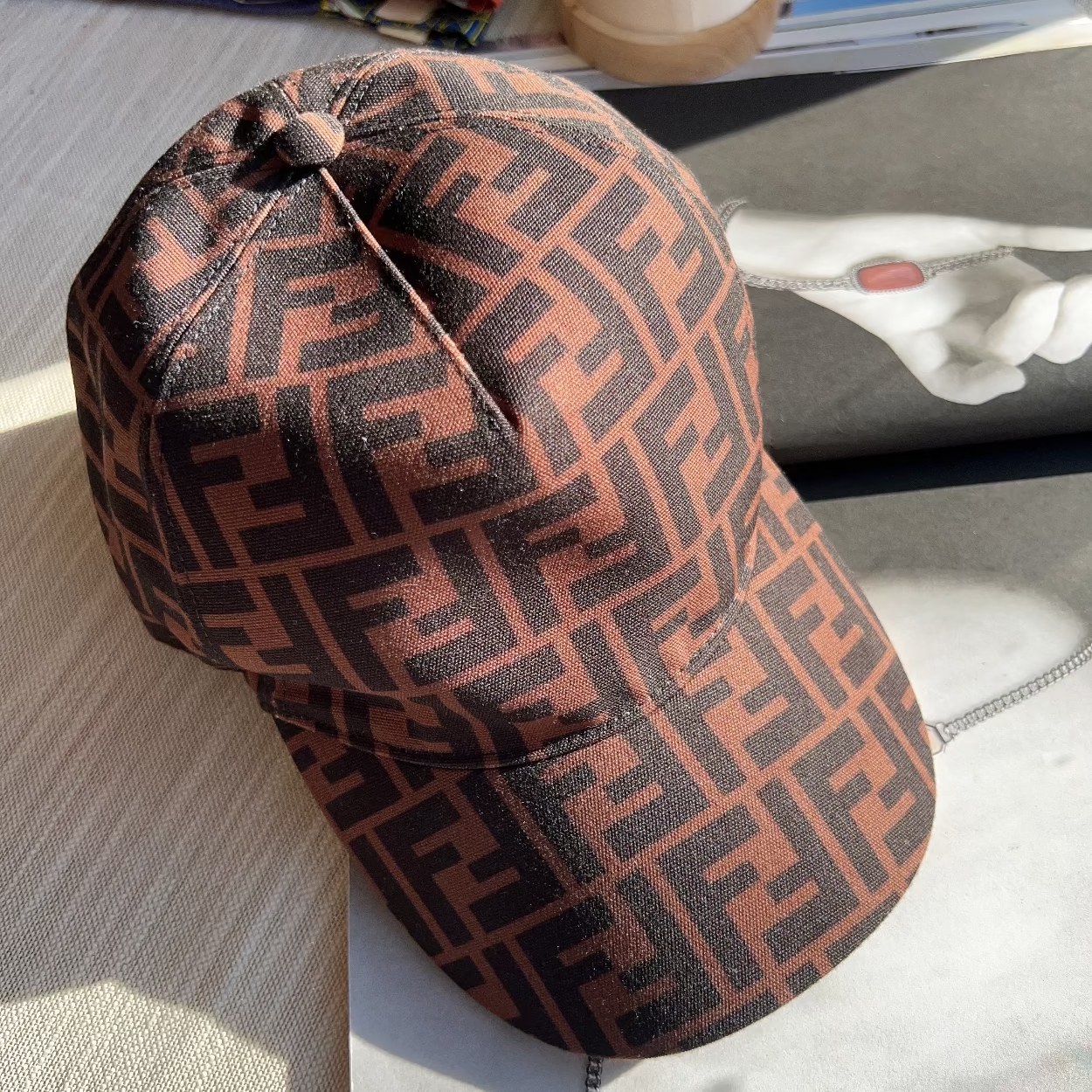 Brown patterned cap on a textured surface with a blurred background