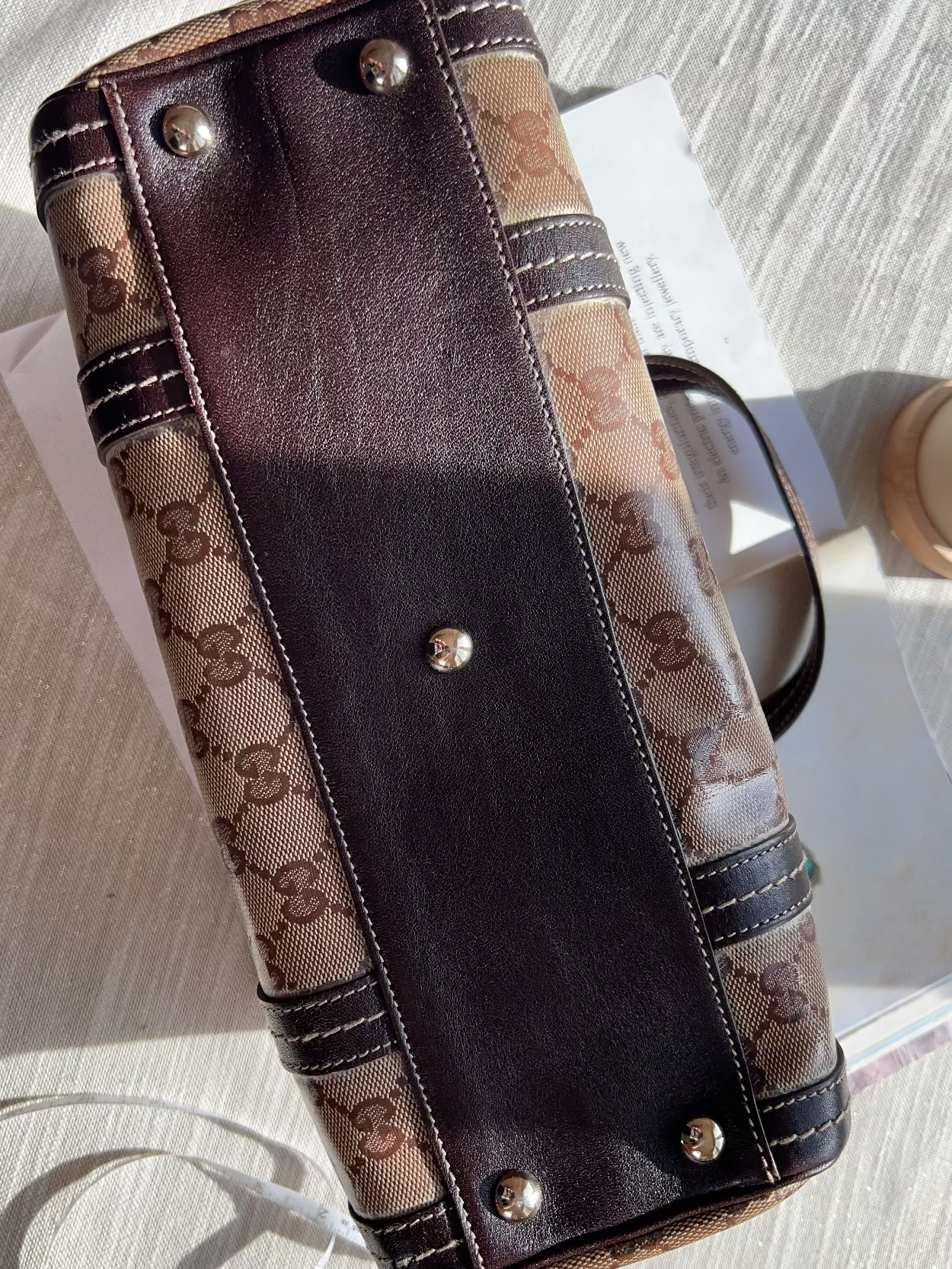 Designer handbag with visible brand logo on a light surface