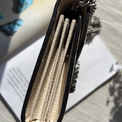 Black case with rolled-up papers on a textured surface