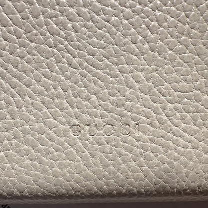 Close-up of a textured beige surface with text partially visible.