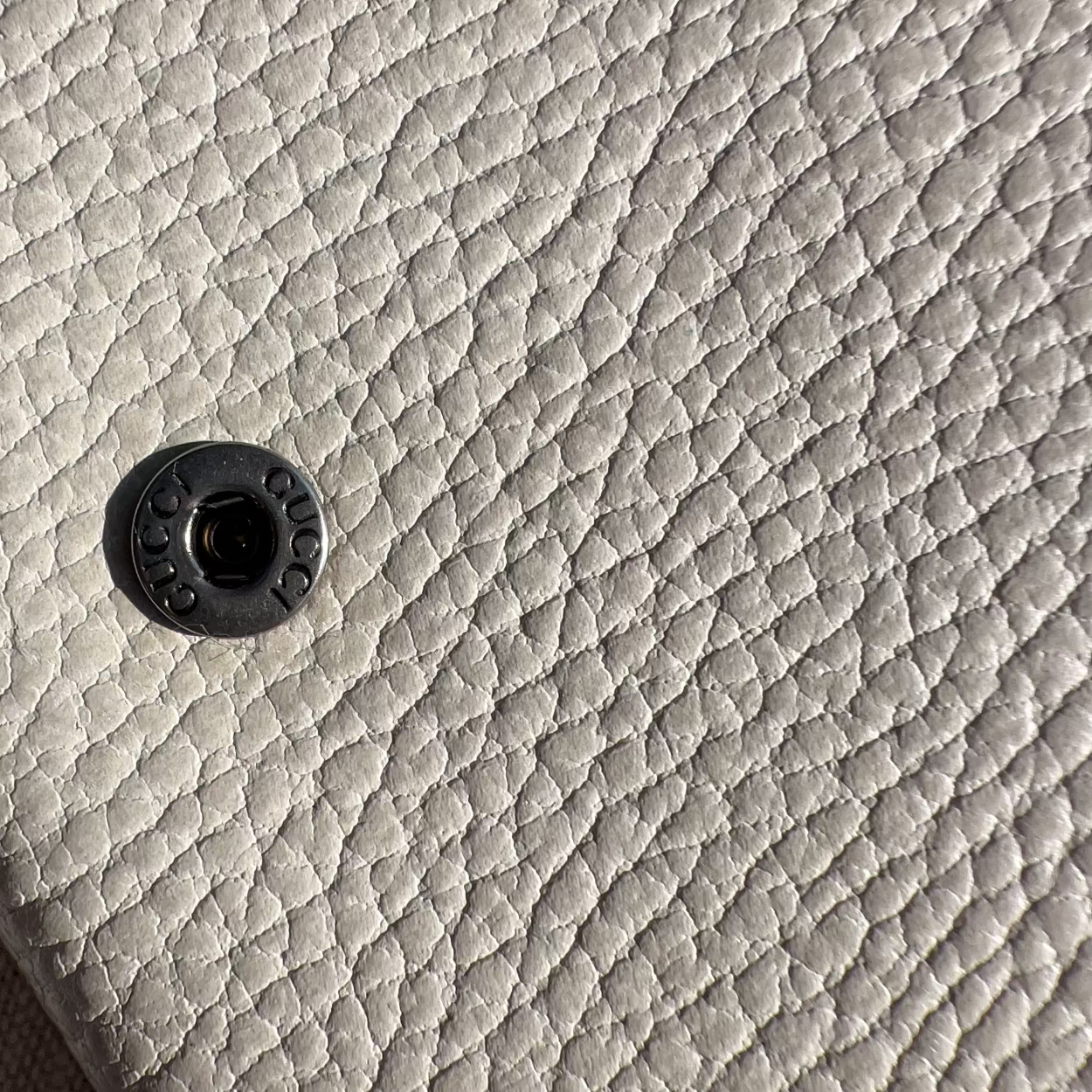 Close-up of a textured gray surface with a central circular detail.
