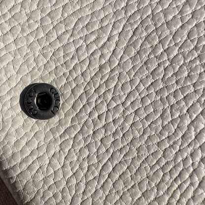Close-up of a textured gray surface with a central circular detail.