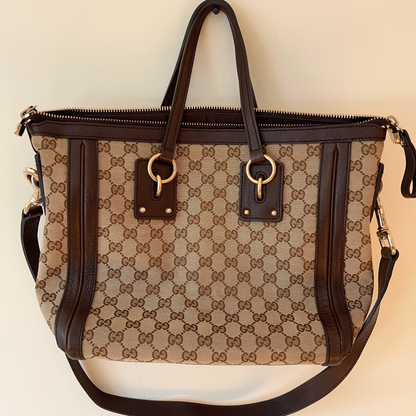Designer handbag with brown and beige pattern on a light background